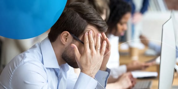  side profile of man with his hands to his forehead looking stressed
