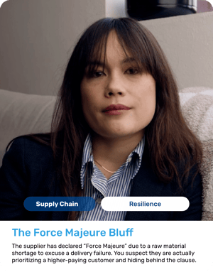 Woman with dark hair and bangs, wearing a blue blazer over a striped shirt. Highly observant expression.